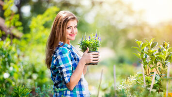 young woman gardening outside in summer